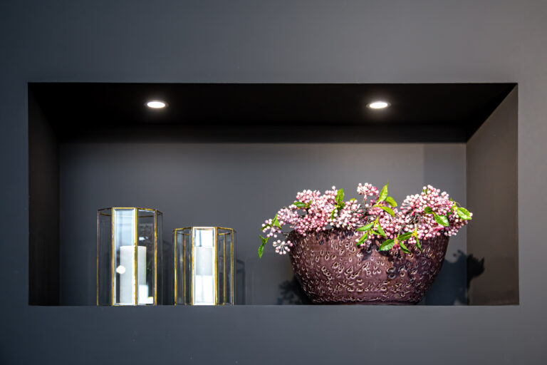 Close-up, vase with flowers and glass candlesticks in the interior of the house.